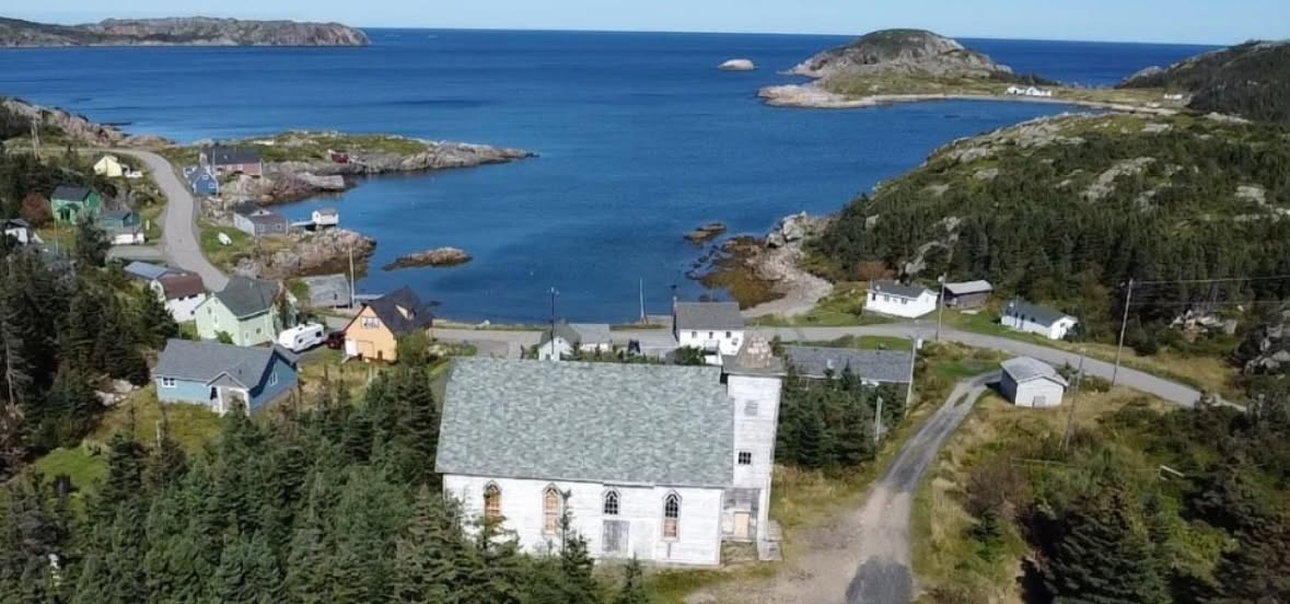 Aerial view of Little Harbour Church above the ocean, Newfoundland